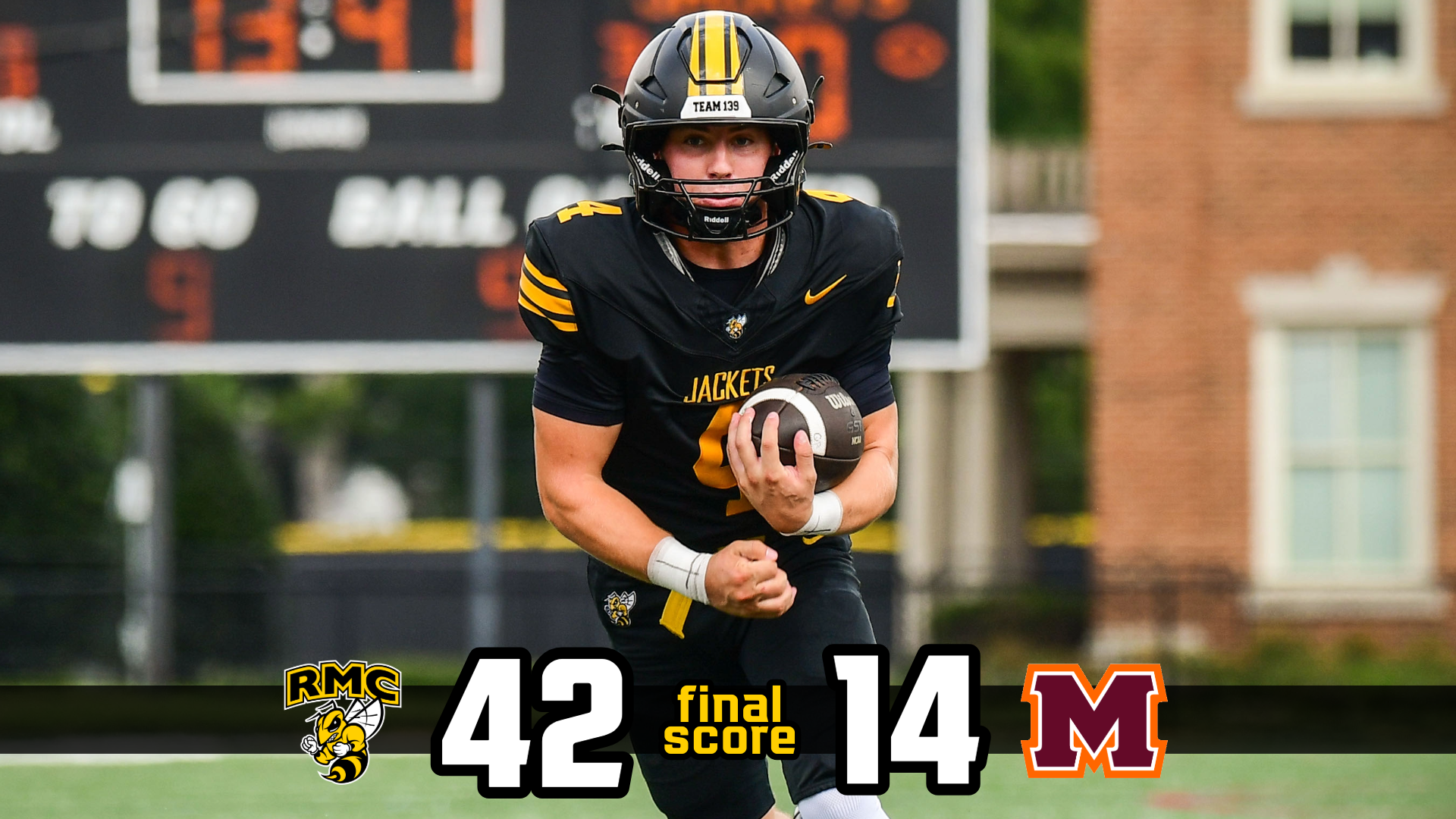 Football Final Score: Jake Mulhern with the football in all black uniform... RMC football wins 42 to 14 against Maryville