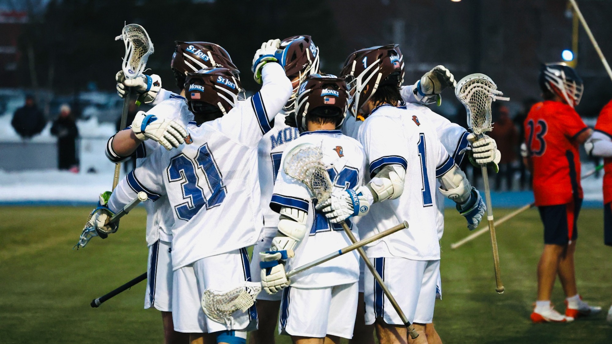 Men's lacrosse team huddle