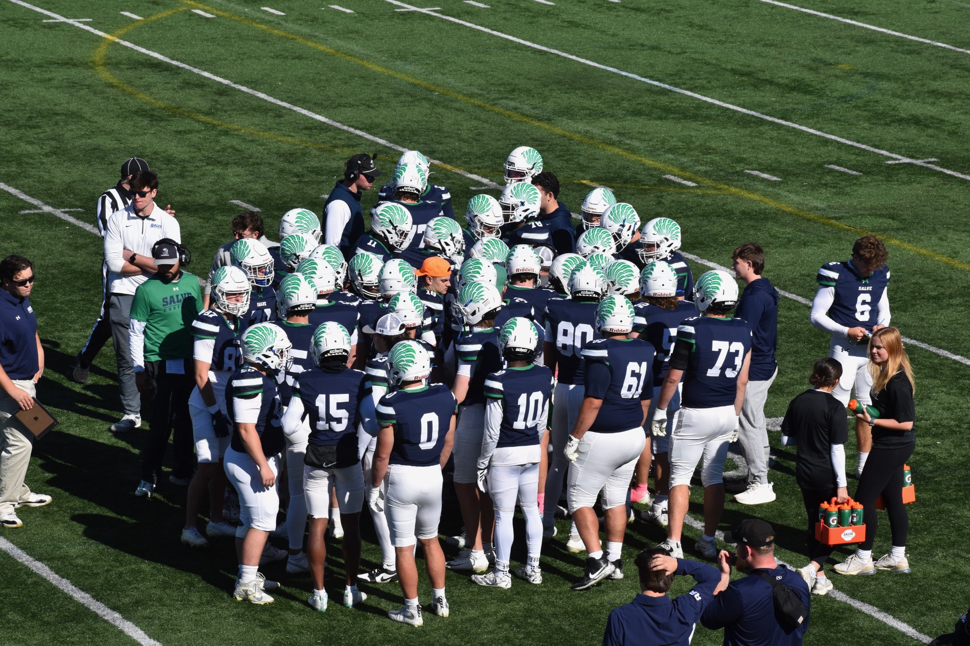 Seahawk defense huddles near the sideline during timeout