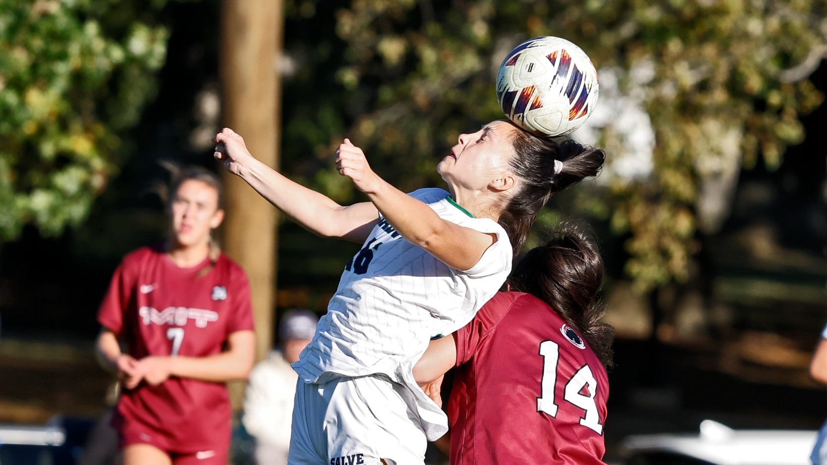 Chelsea Hartsburg elevates for a header