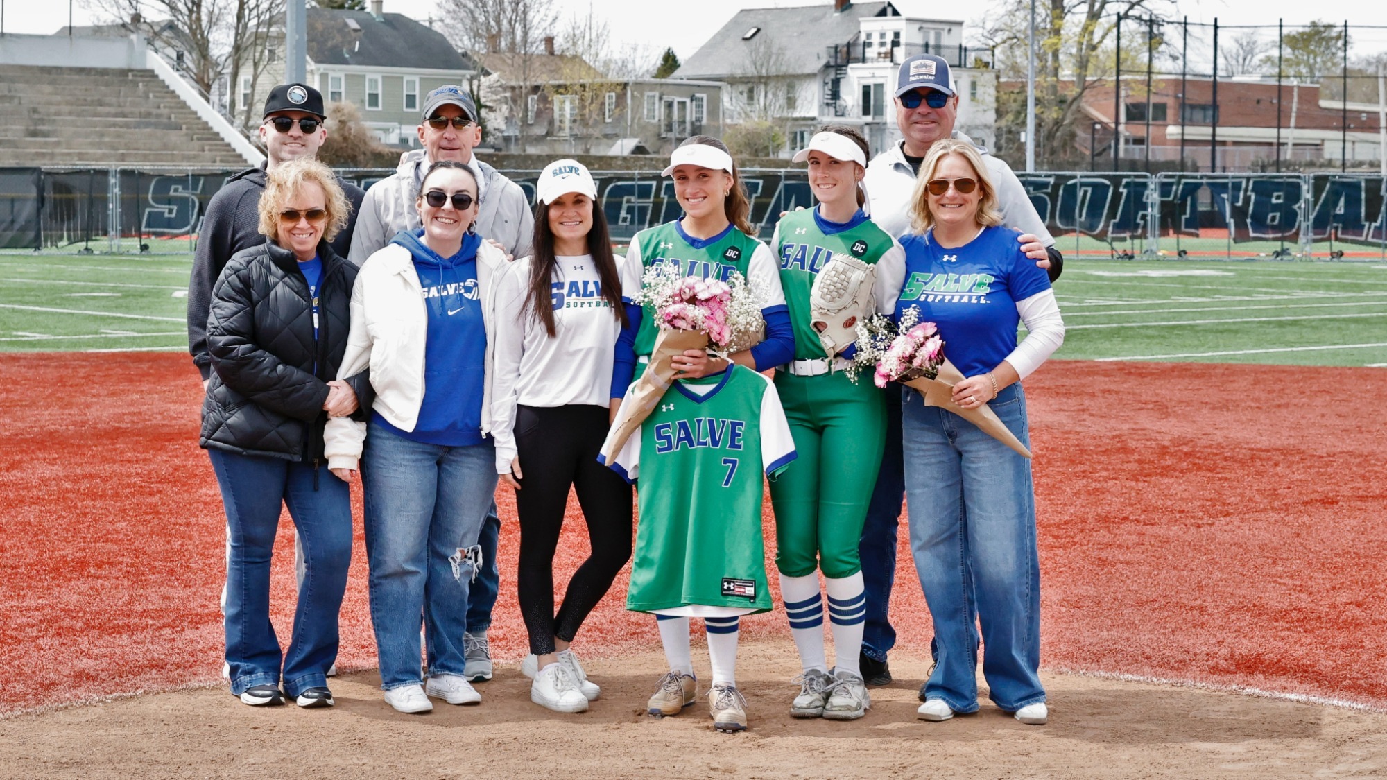 Caroline Peterson and Skylar Wicklund with their families on Senior Day