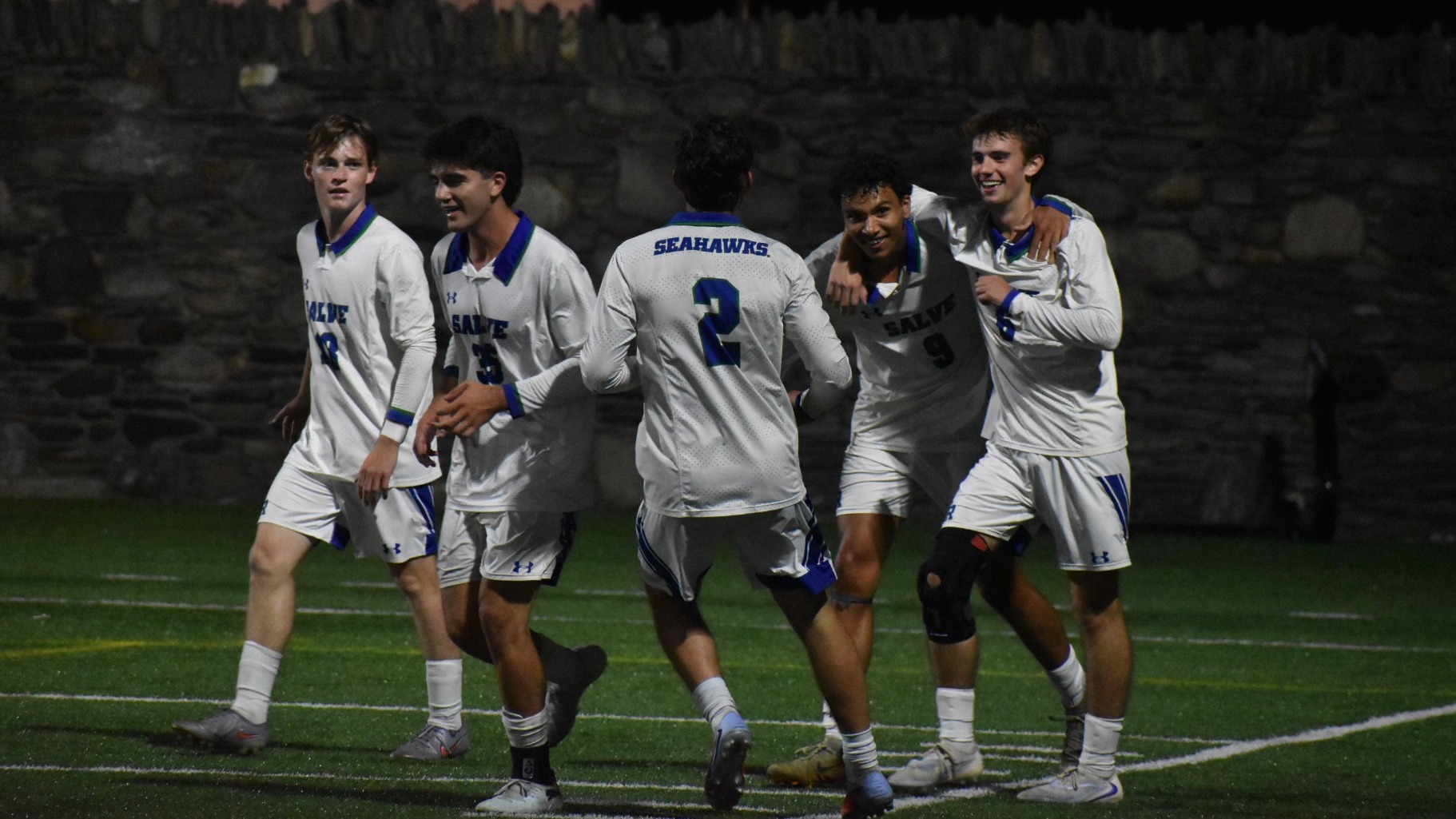 Ty Ferris (#9) celebrates with teammates after scoring his third goal of game against Owls