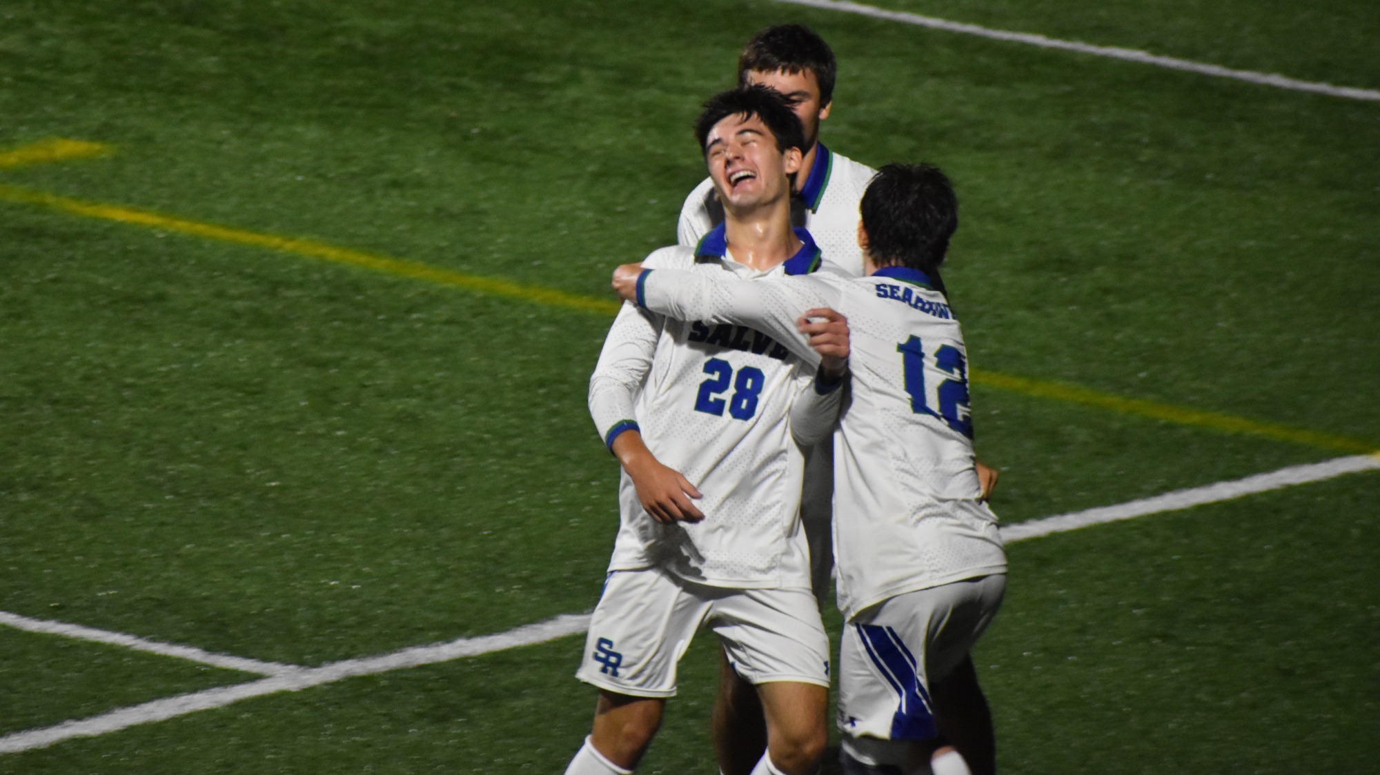 Joey Francalangia gets congratulatory hugs from his Seahawk teammates