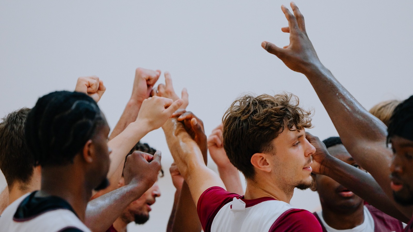 MBB Team Huddle with Fists Closeup 