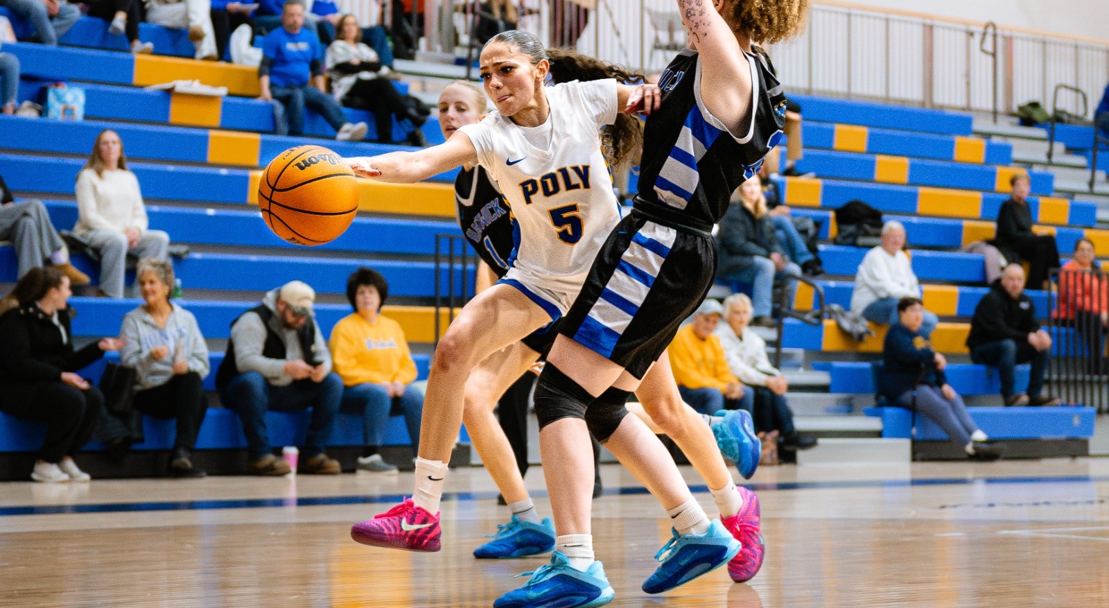 WBB player dribbles past defender