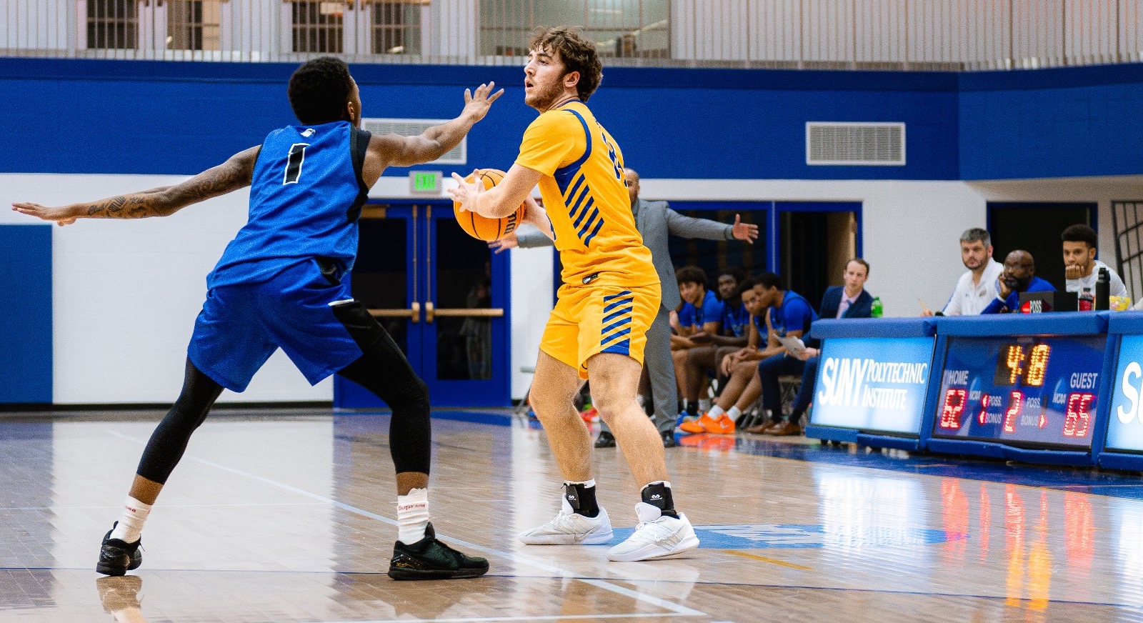 Men’s basketball players scans the floor  