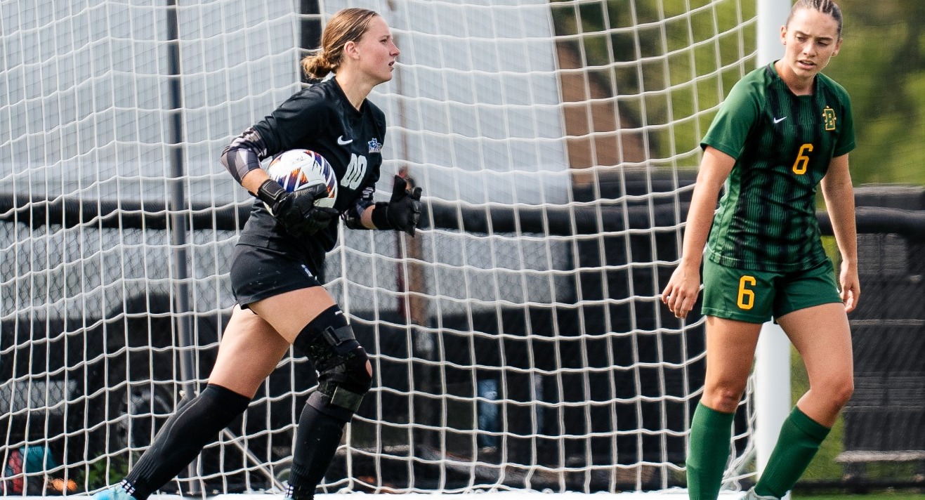 SUNY POLY women's soccer goalie surveys the field after stopping opposing teams shot