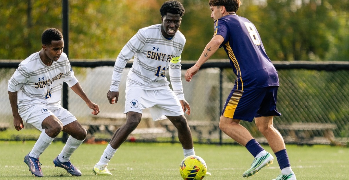 SUNY POLY men's soccer players guard opponent from home goalkeeper