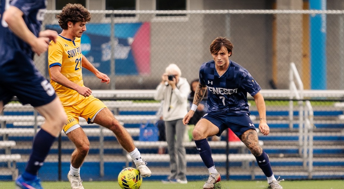 SUNY POLY Men's soccer players dribbles past the defenders and up the field