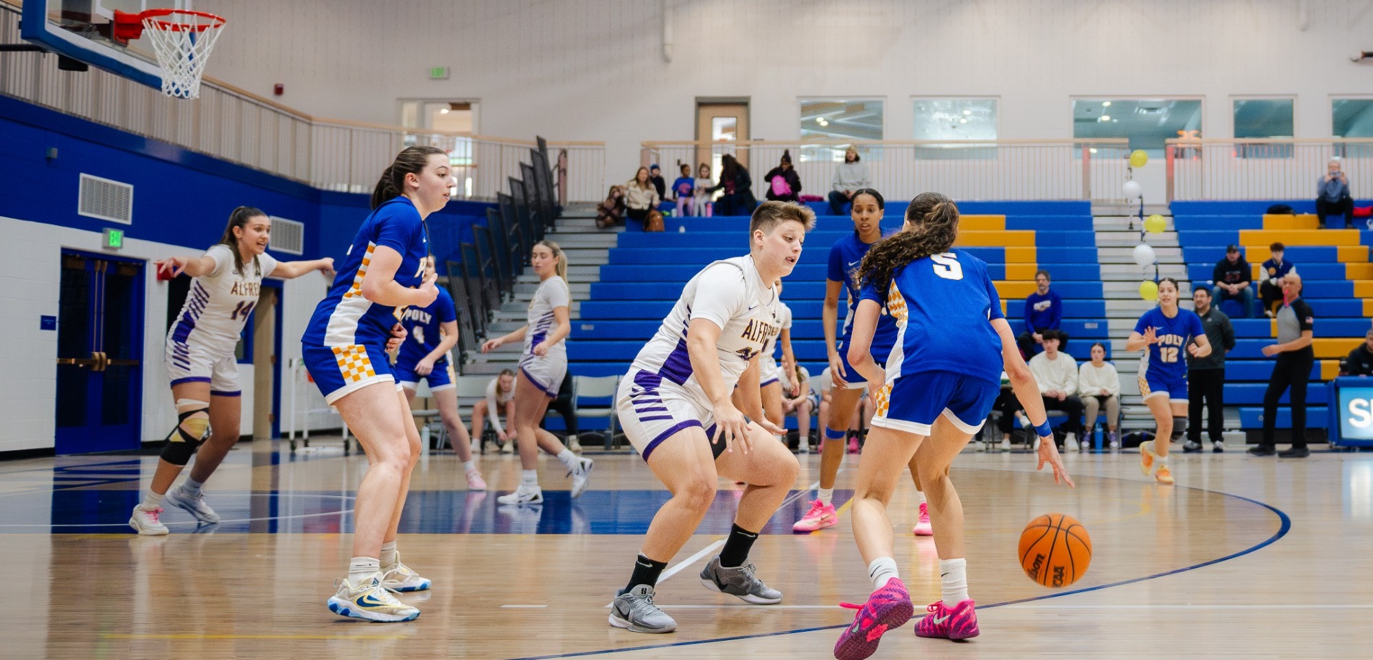 SUNY Poly women's basketball player uses a screen from a teammate 