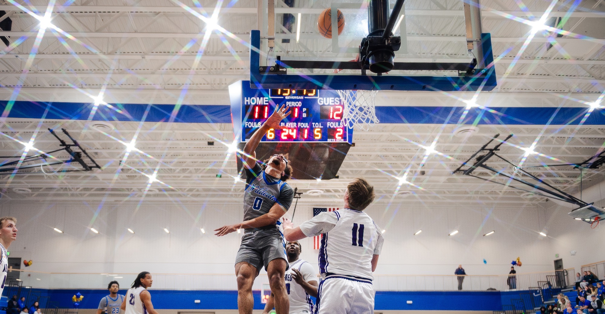 SUNY Poly men’s basketball player rises up for a layup 