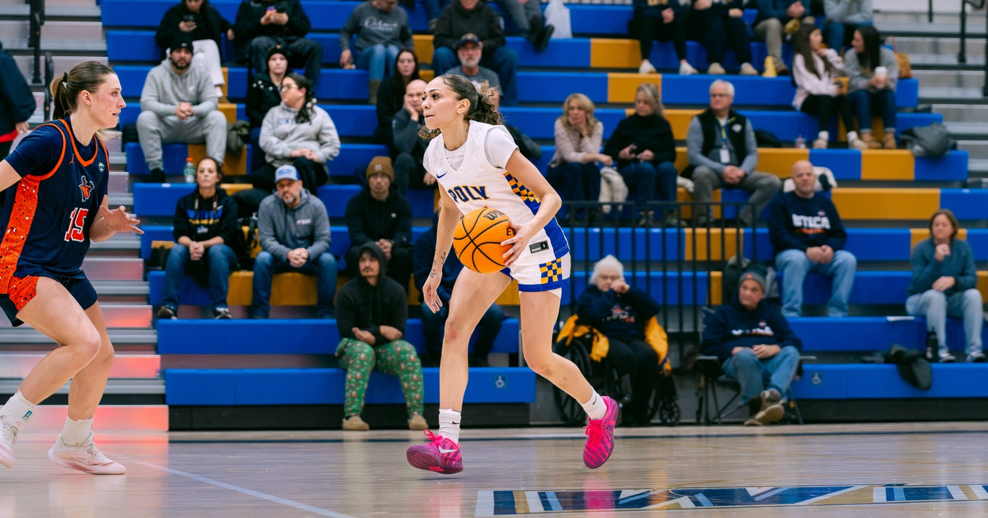 SUNY Poly women's basketball player dribbles up the court