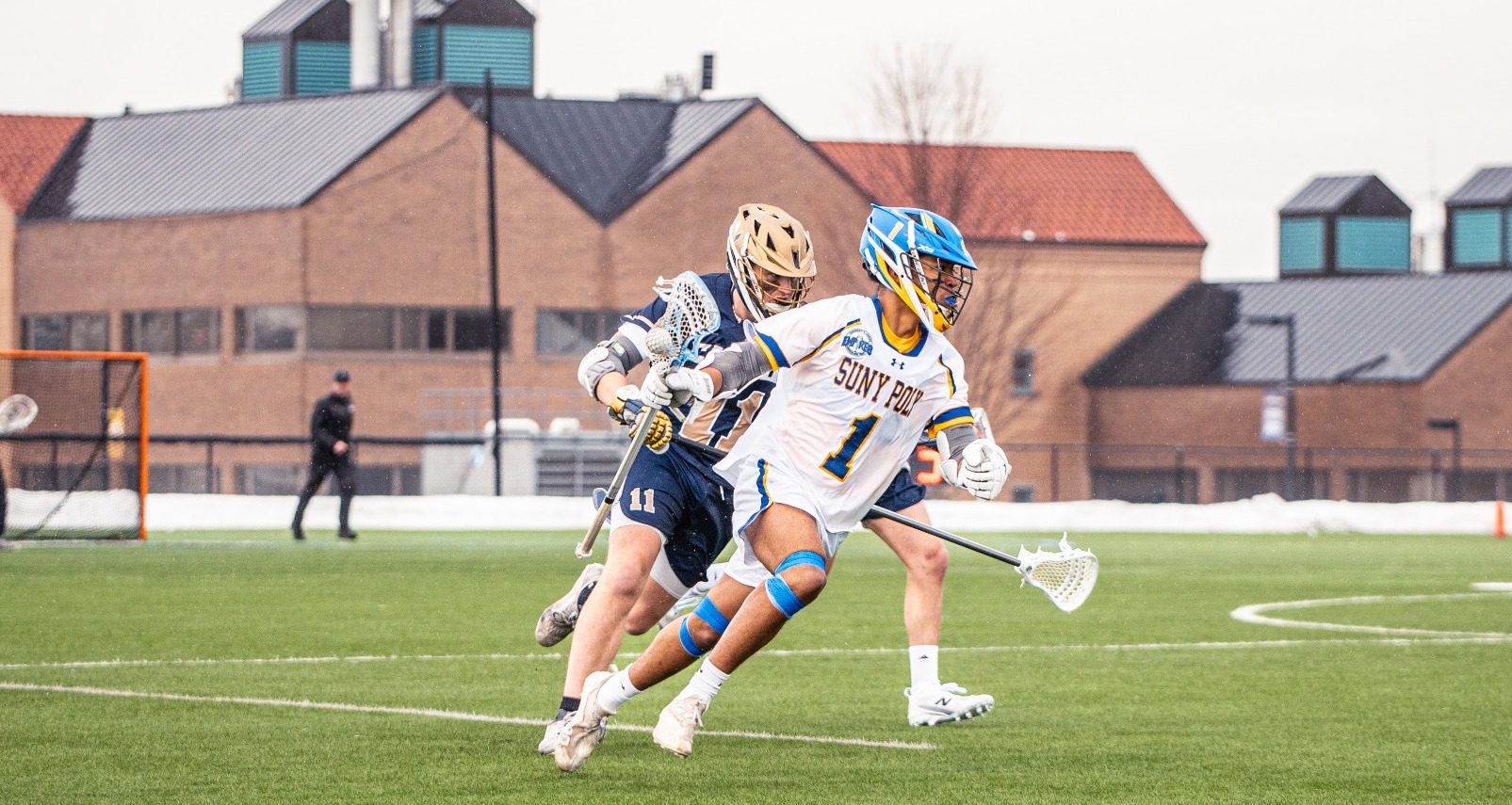 SUNY POLY Midfielder, Kai Hew, rushes past defender for chance to score a goal 