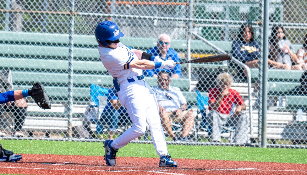 SUNY POLY baseball player takes a swing at incoming pitch 