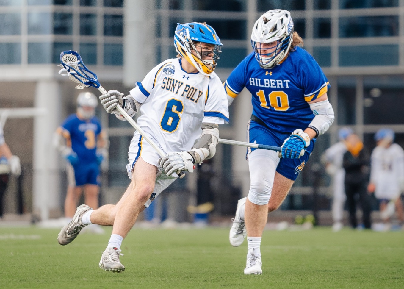 SUNY POLY lacrosse player makes effort to get around opposing defender