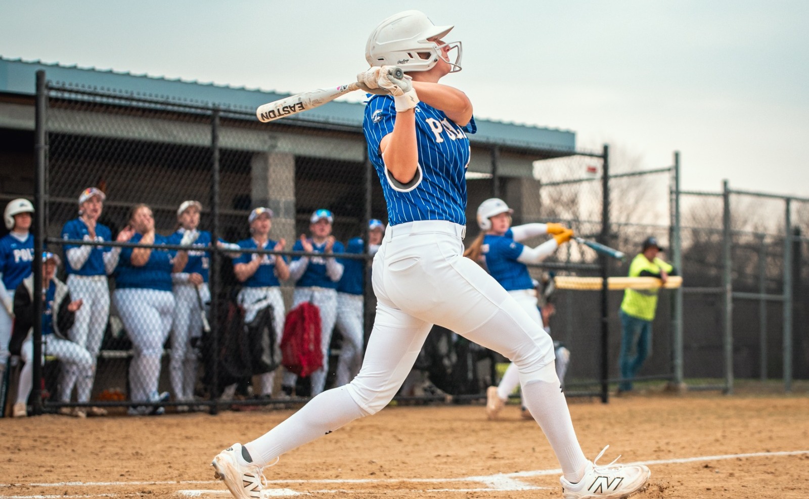 SUNY Poly softball player takes a swing at incoming pitch