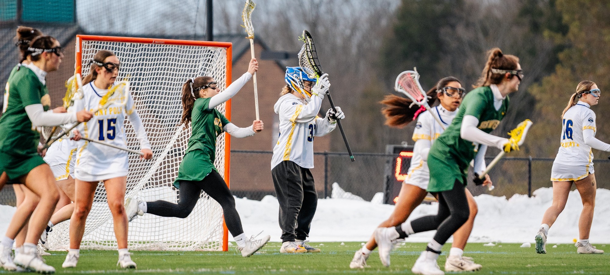 SUNY Poly lacrosse players defend their side of the turf