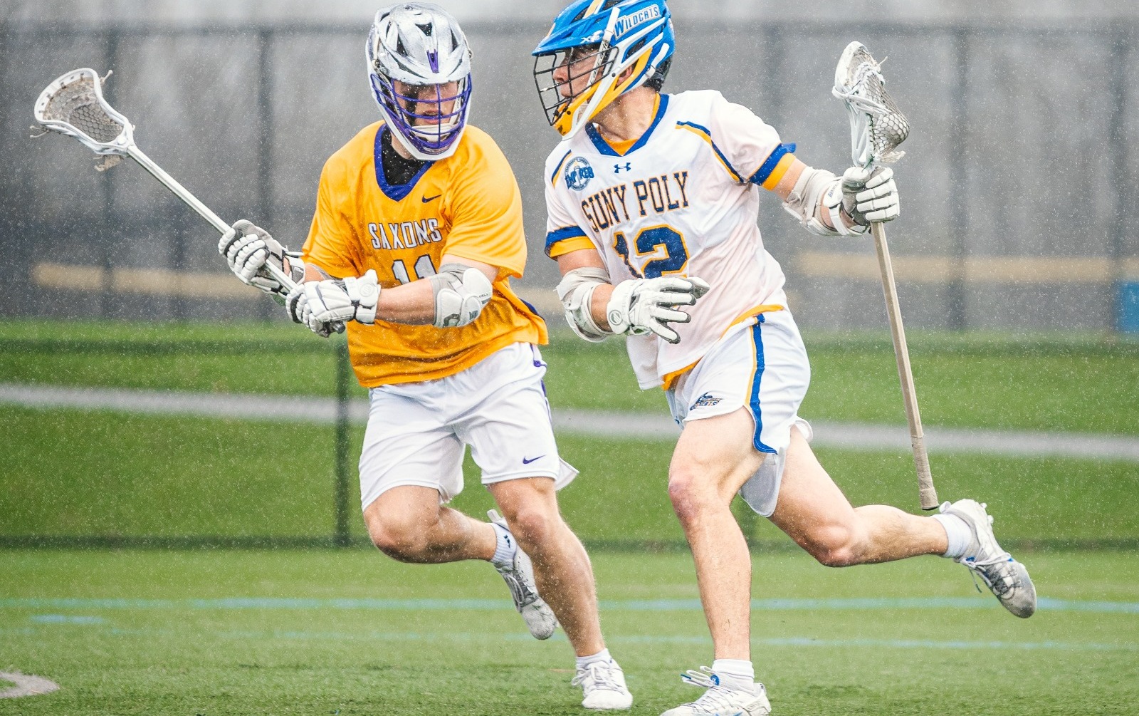 SUNY POLY lacrosse players make an effort to get past the opposing defenders