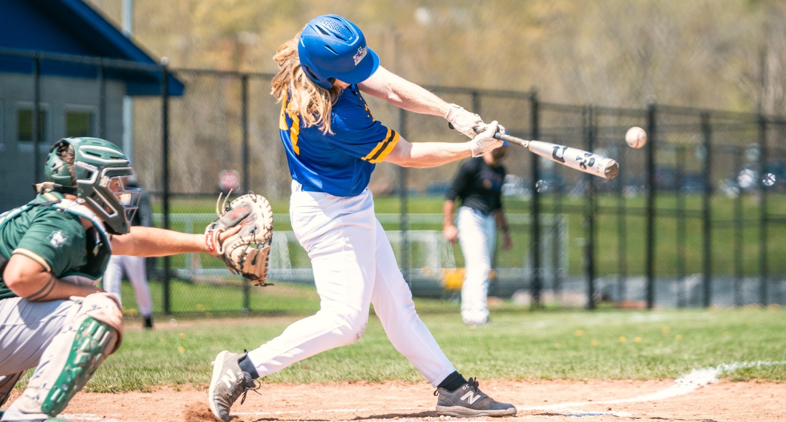 SUNY POLY baseball players takes a swing at incoming pitch