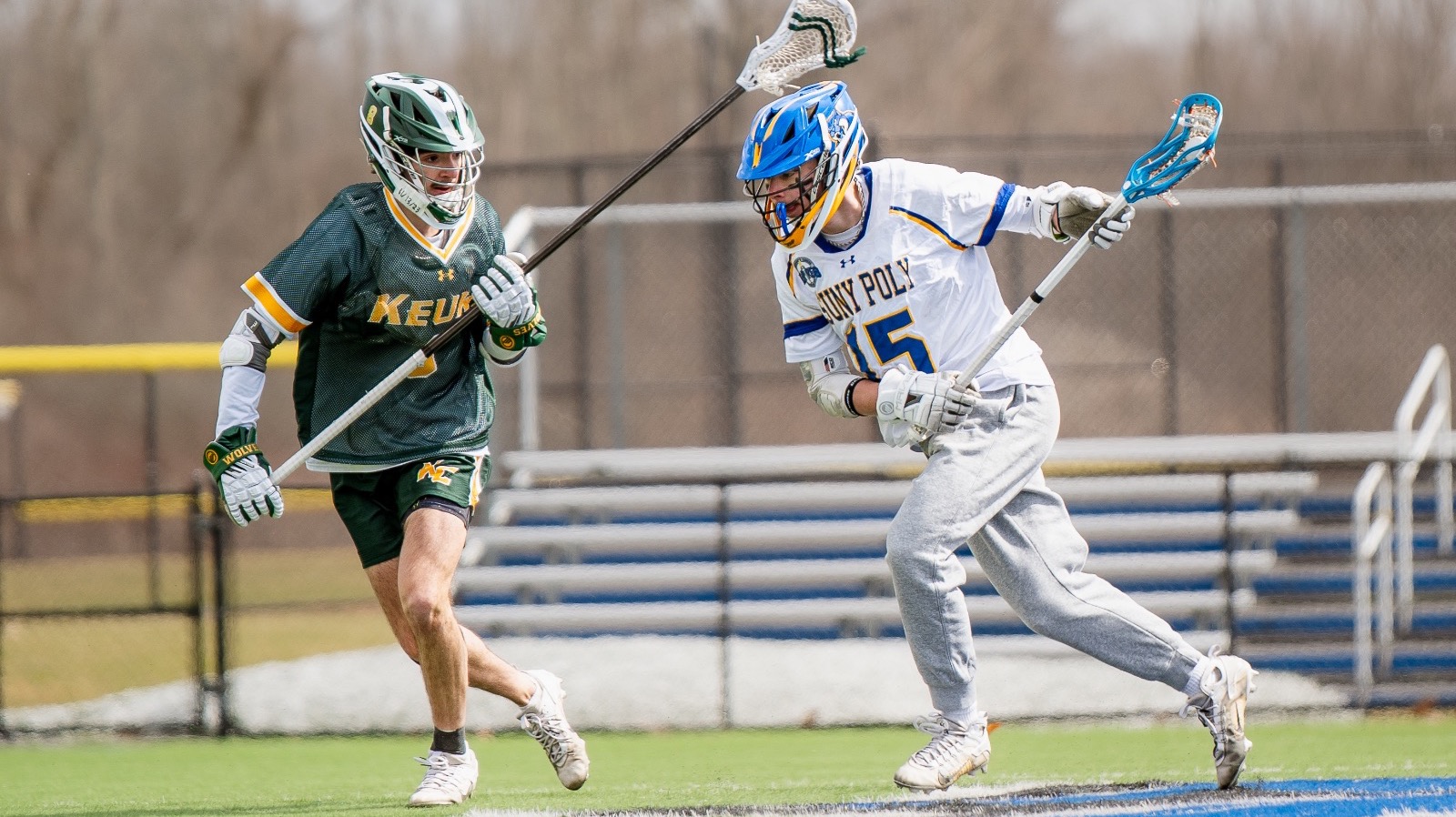 Men’s lacrosse player charges upfield in a attempt to clear the ball