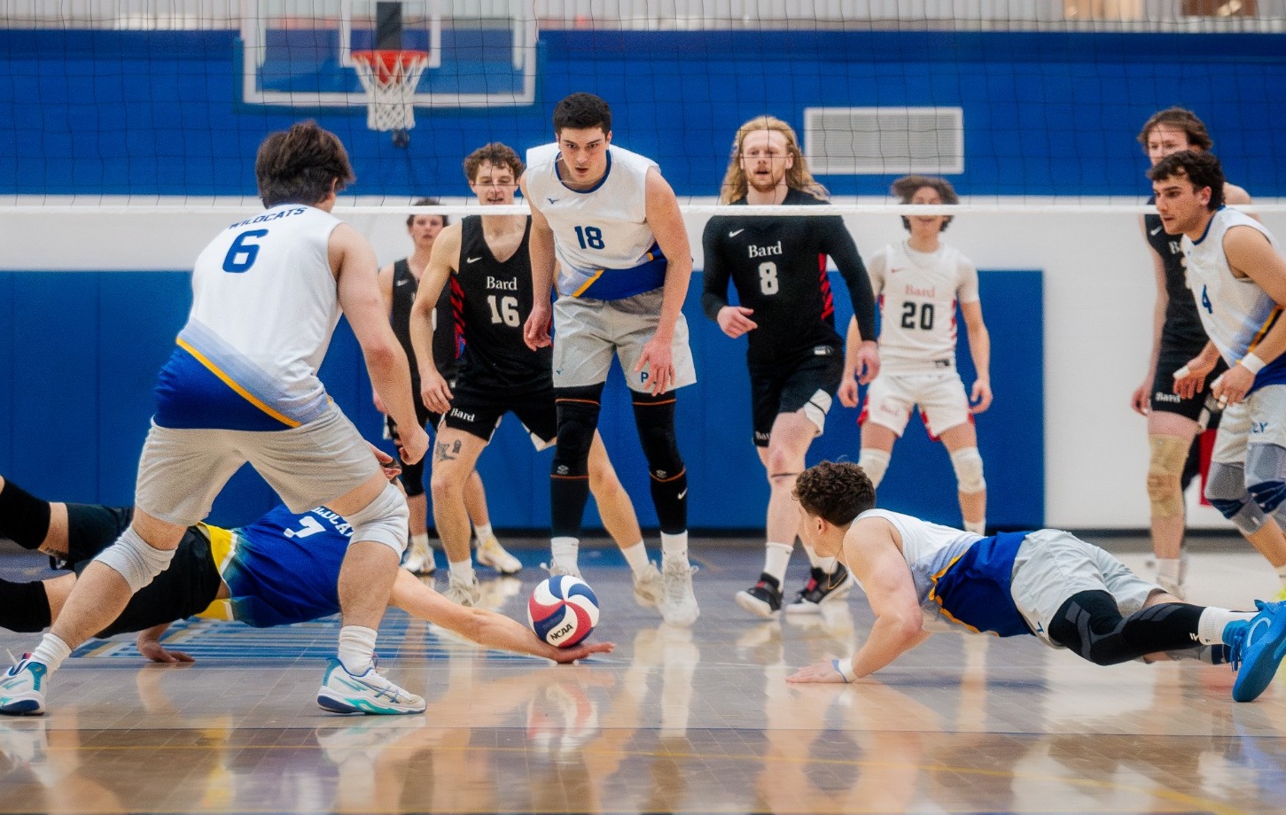 SUNY POLY volleyball players make strong effort to keep the ball alive for rally