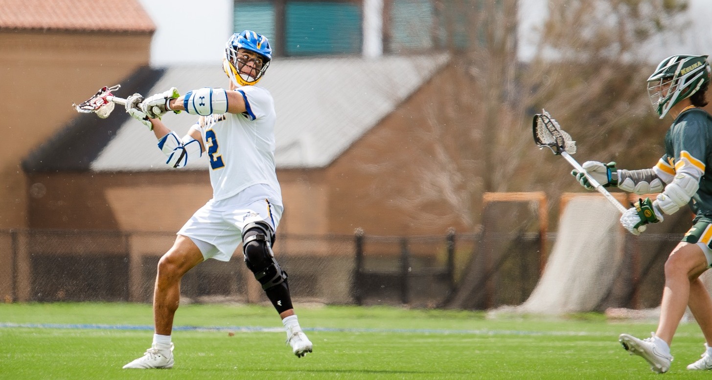 SUNY Poly men's lacrosse player winds up to take a shot on goal