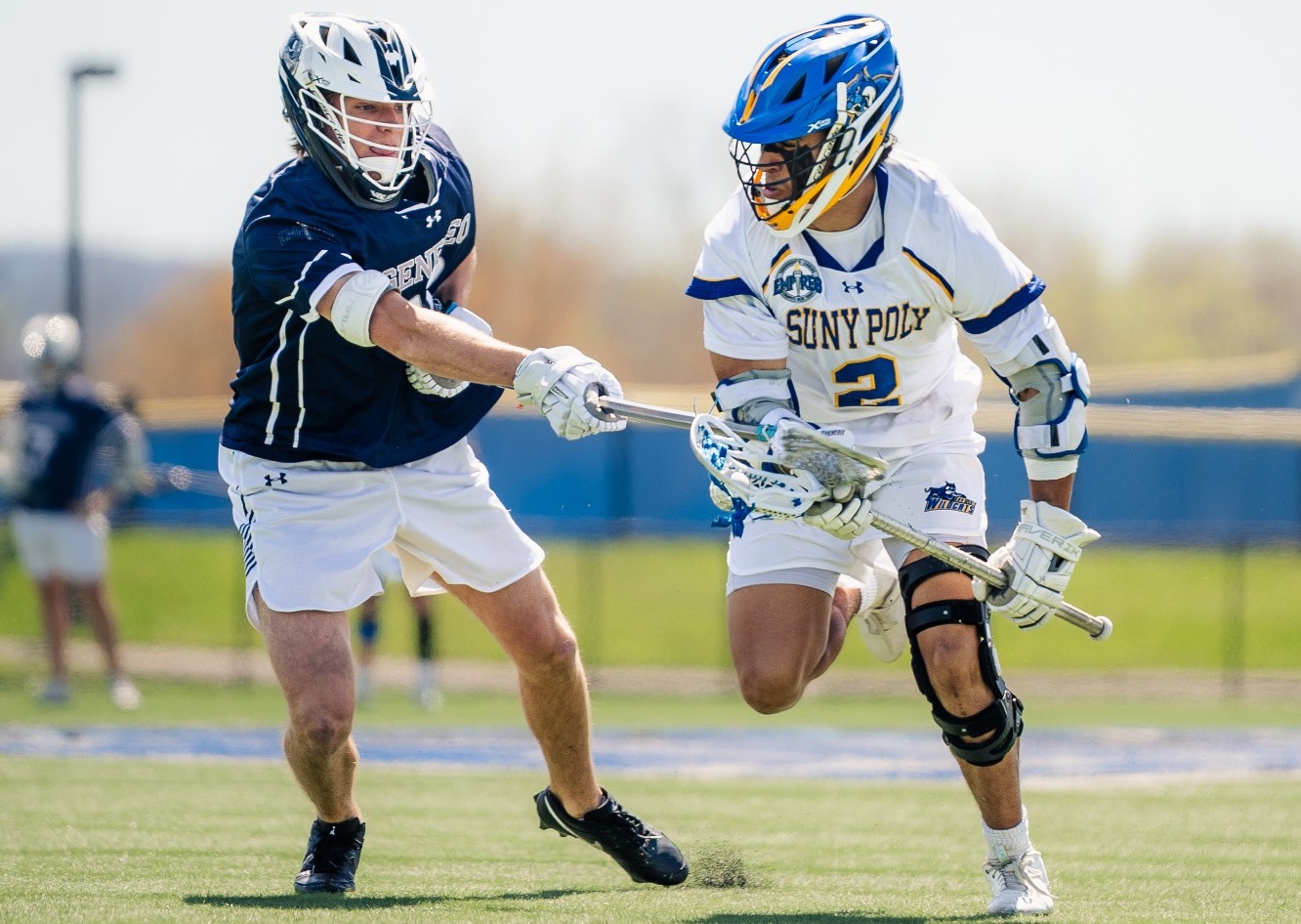 SUNY Poly men's lacrosse player fights for positioning on the field