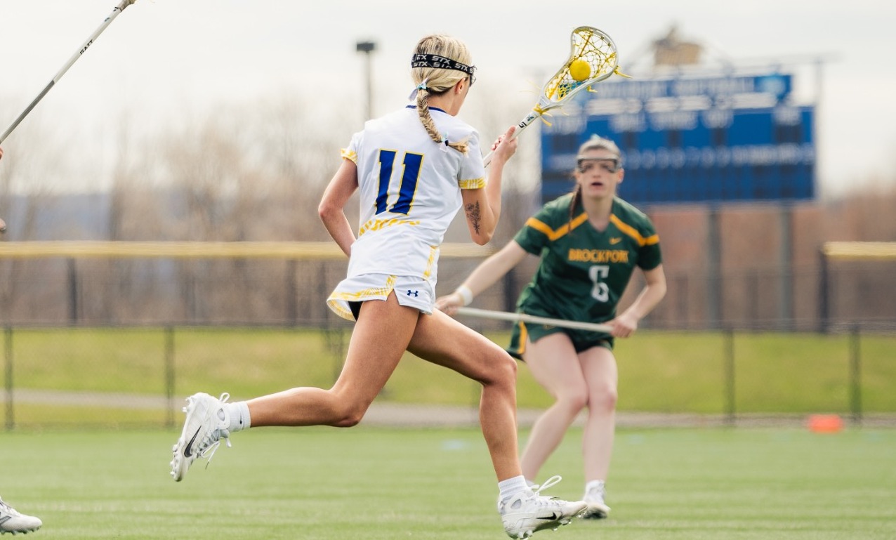 SUNY Poly women's lacrosse players charges upfield attempting to make a play for her team