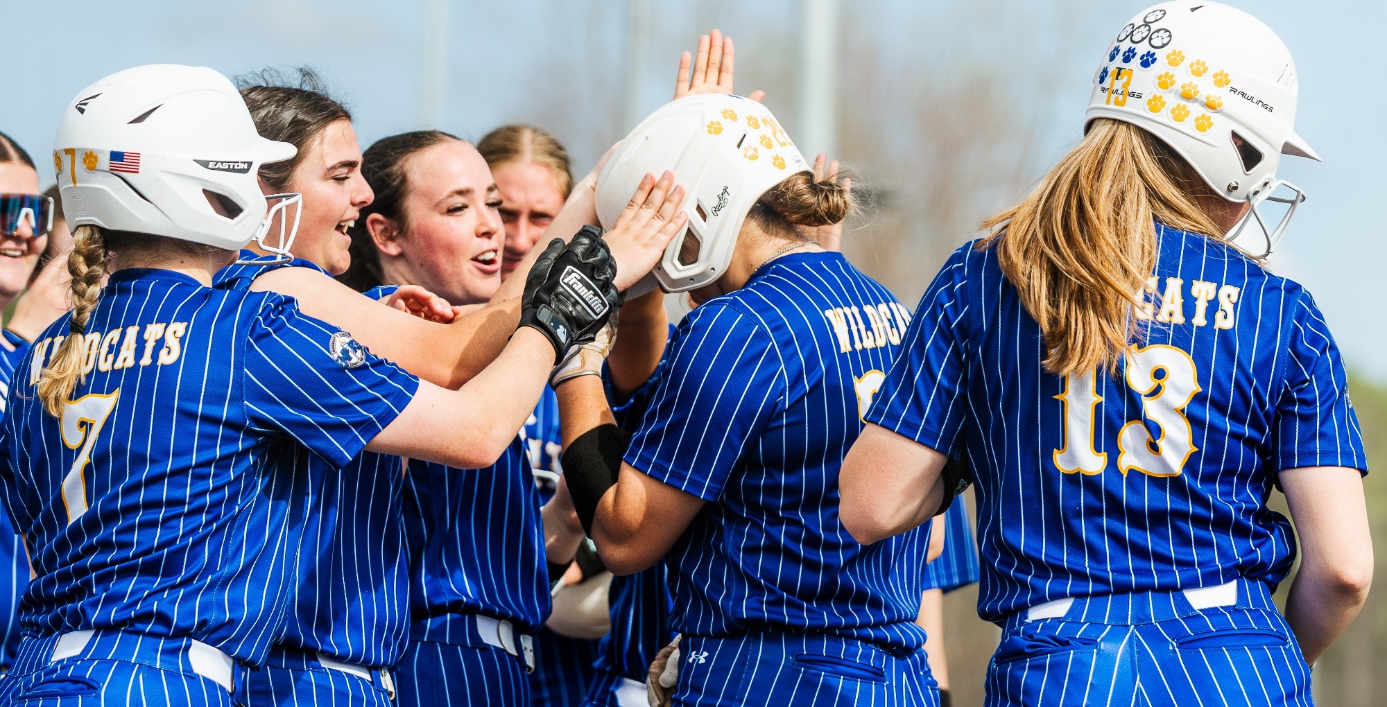 SUNY POLY Softball team celebrates a home run 