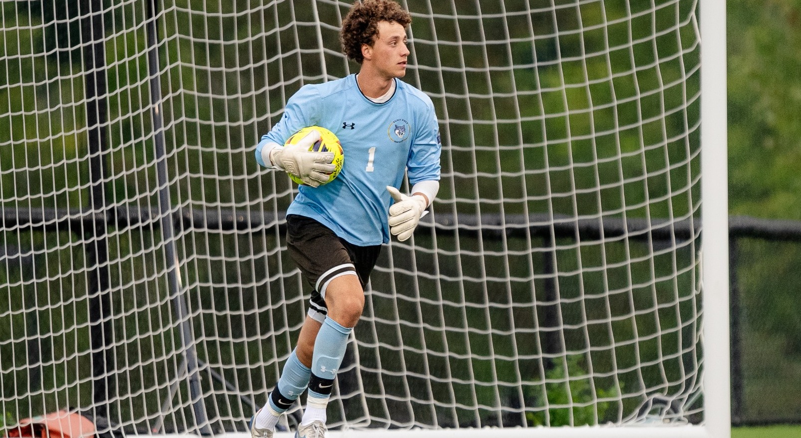 SUNY POLY men's soccer goalkeeper reads the field after making a save