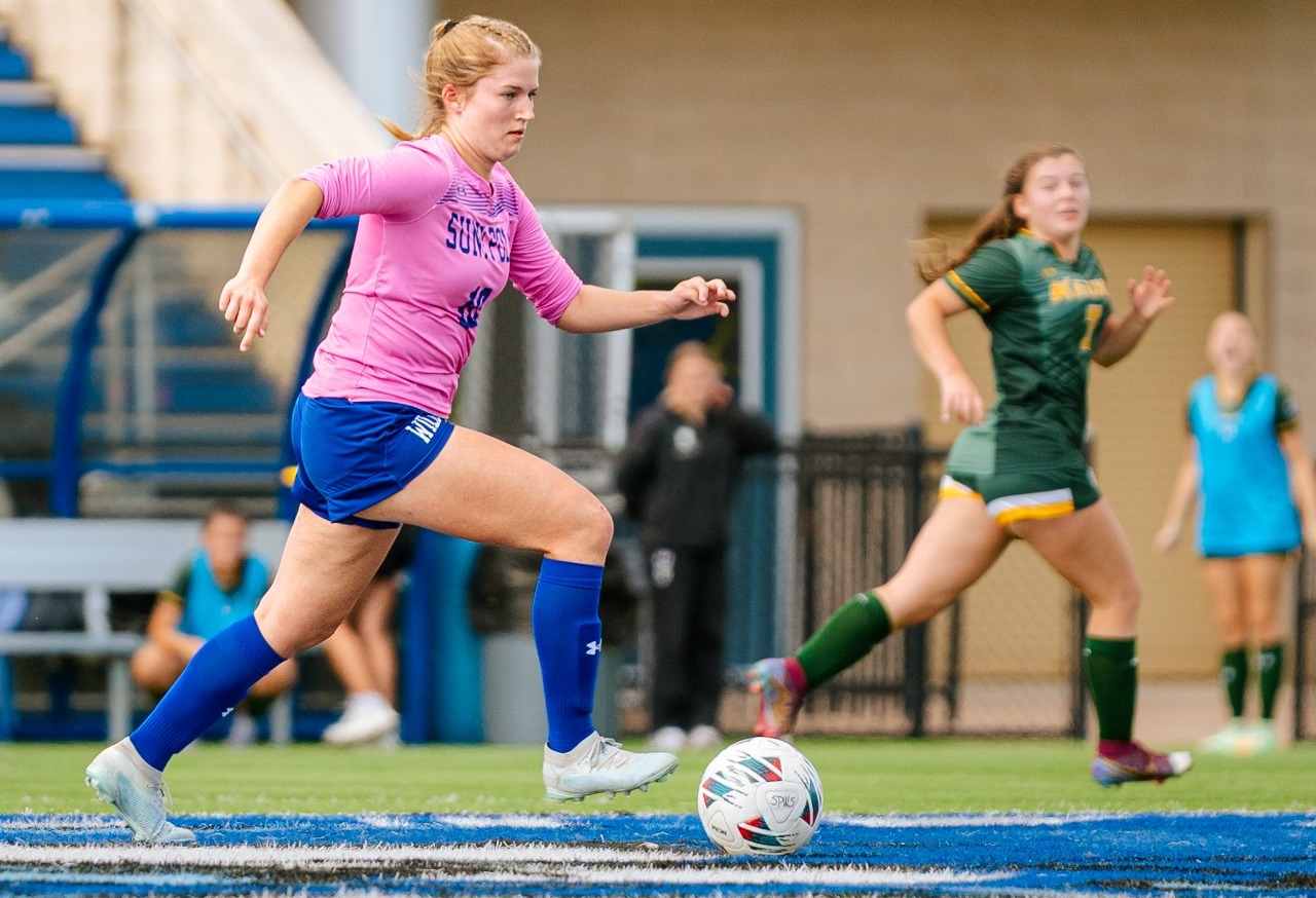 SUNY POLY attacker dribbles through opposing defense