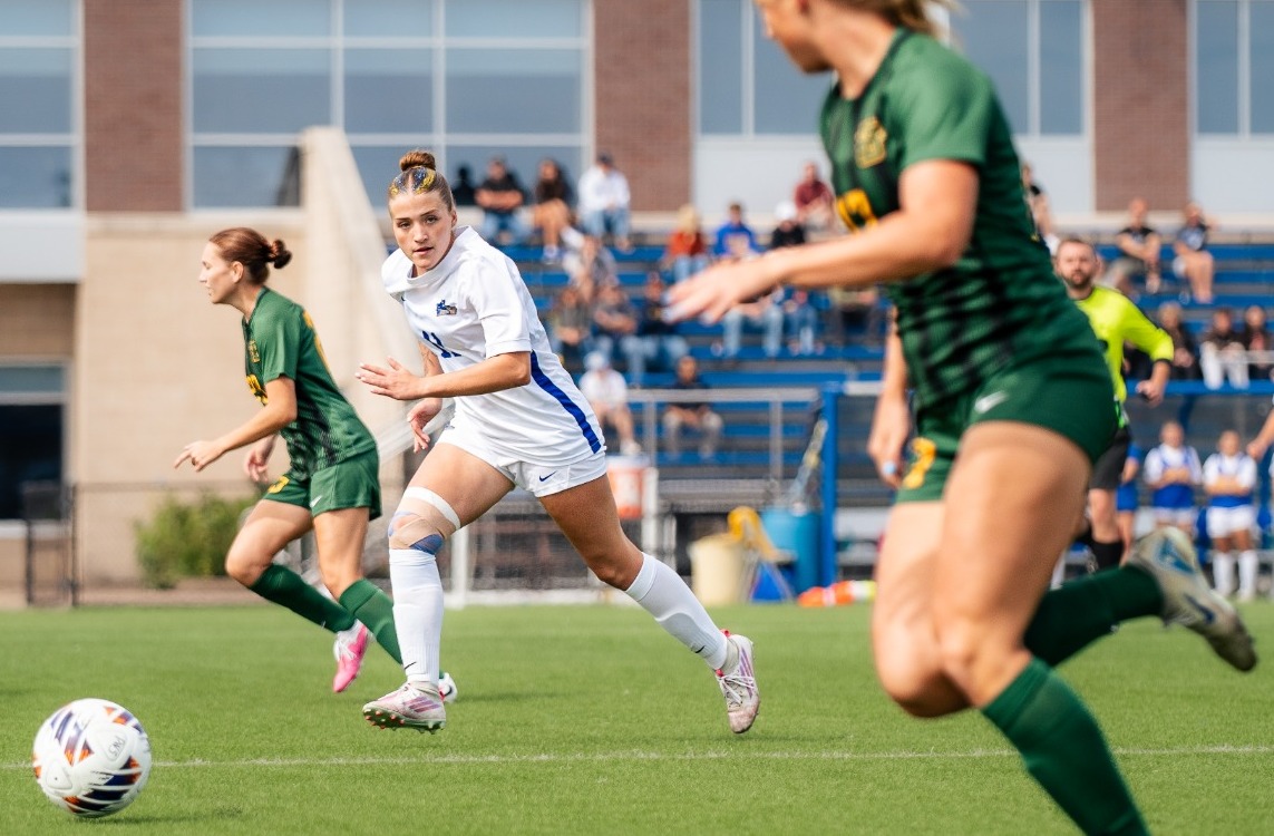 SUNY Poly women's soccer plays tracks down defender with possession of the ball