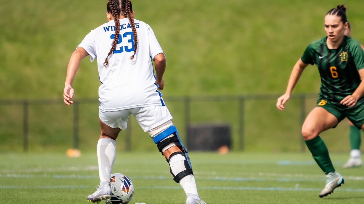 SUNY POLY Forward makes an effort to get by opposing defender