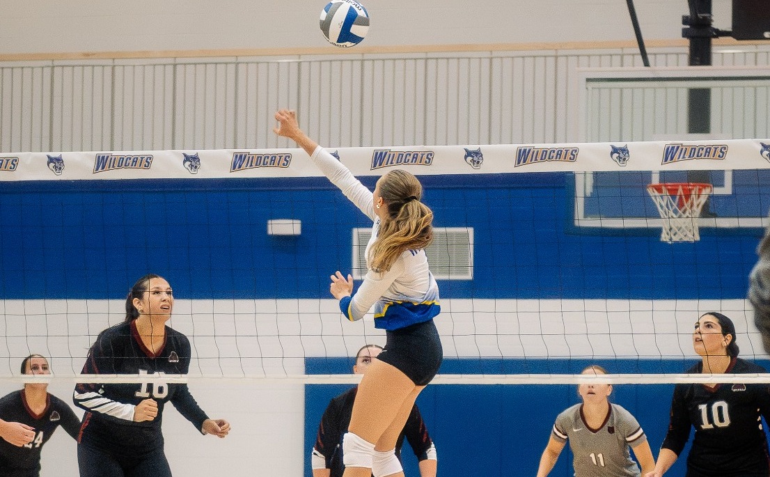 SUNY Poly women's volleyball player send the ball over the net in an effort to secure a point for the home team