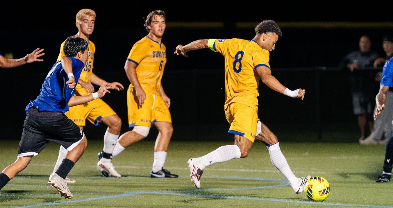 SUNY Poly men's soccer player takes a shot from outside the box