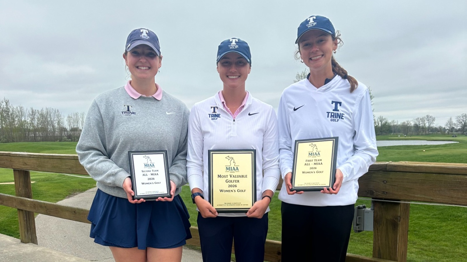 Three Trine Women's Golfers holding plaques