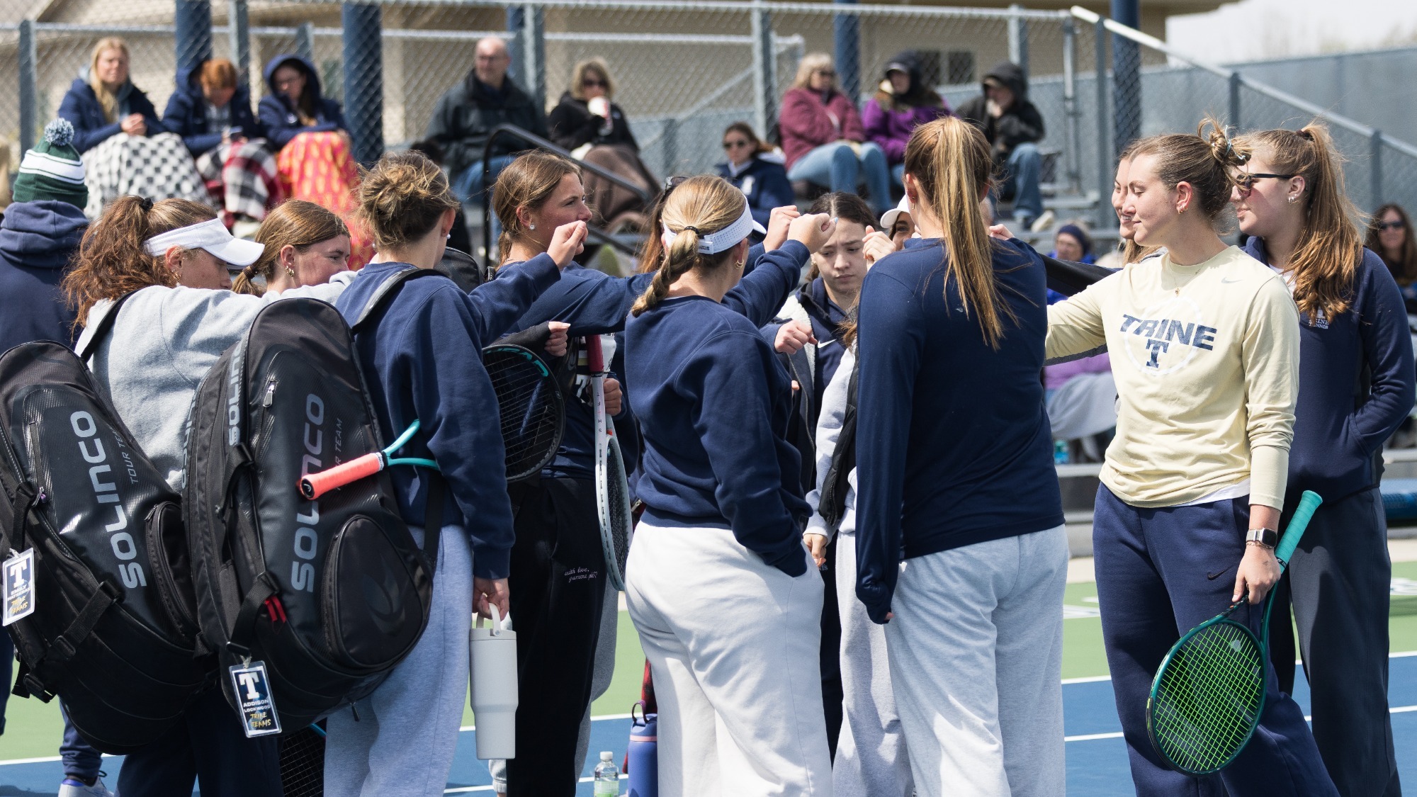 Women's Tennis huddle before match against Alma