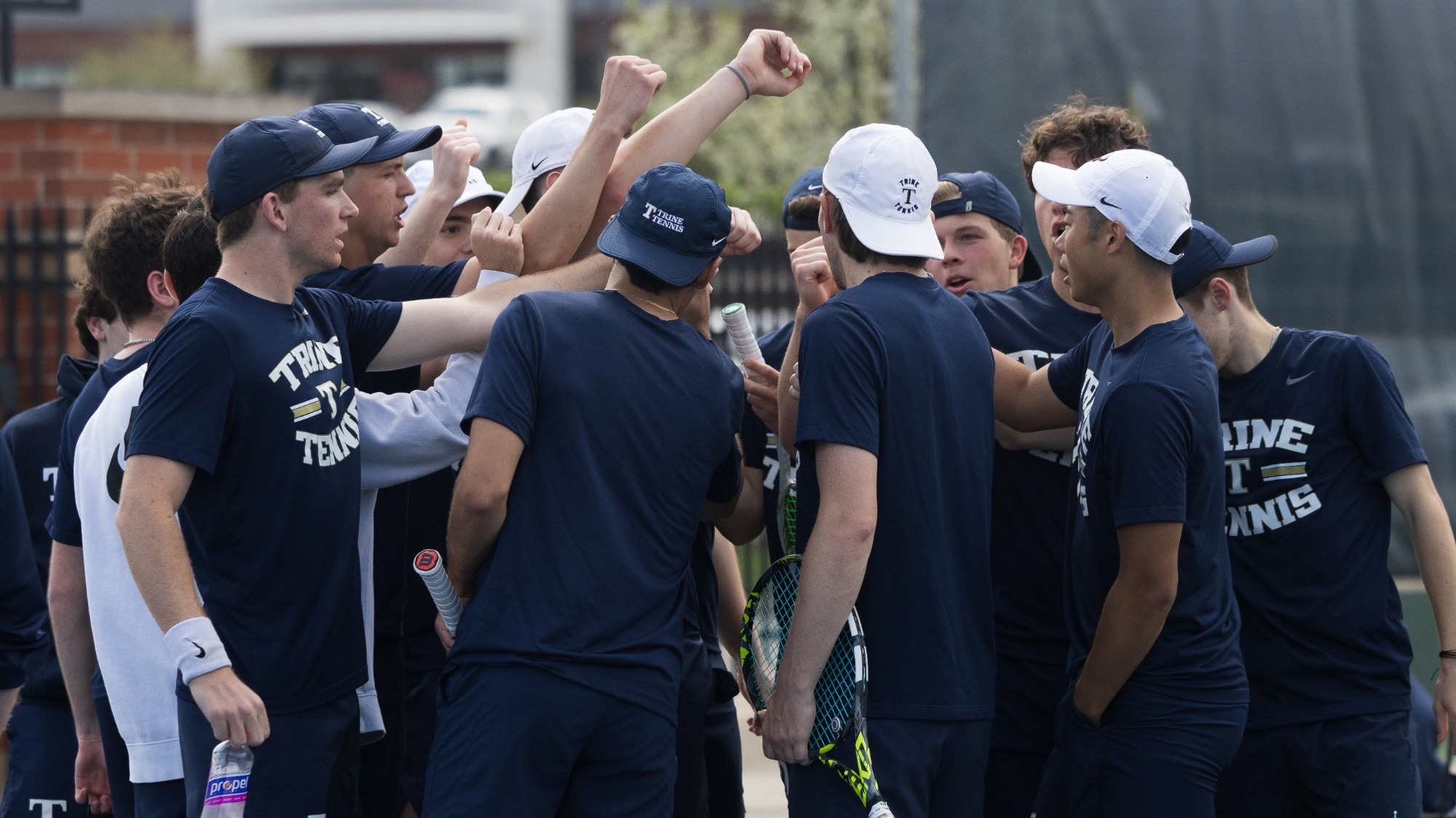 Men's Tennis huddles before match against Kalamazoo