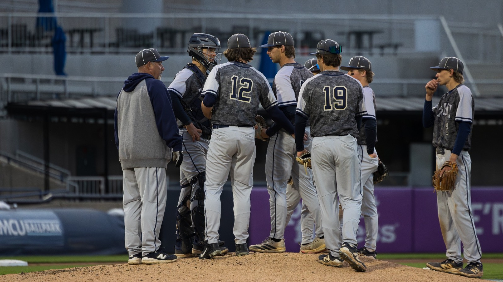 The Trine Baseball team on the mound at LMCU Ballpark