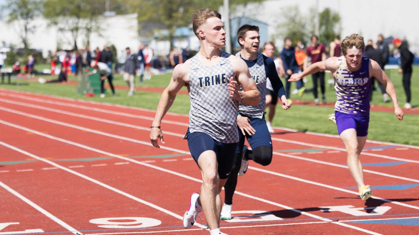 Braden Estep finishes the 100 dash at the MIAA Championships