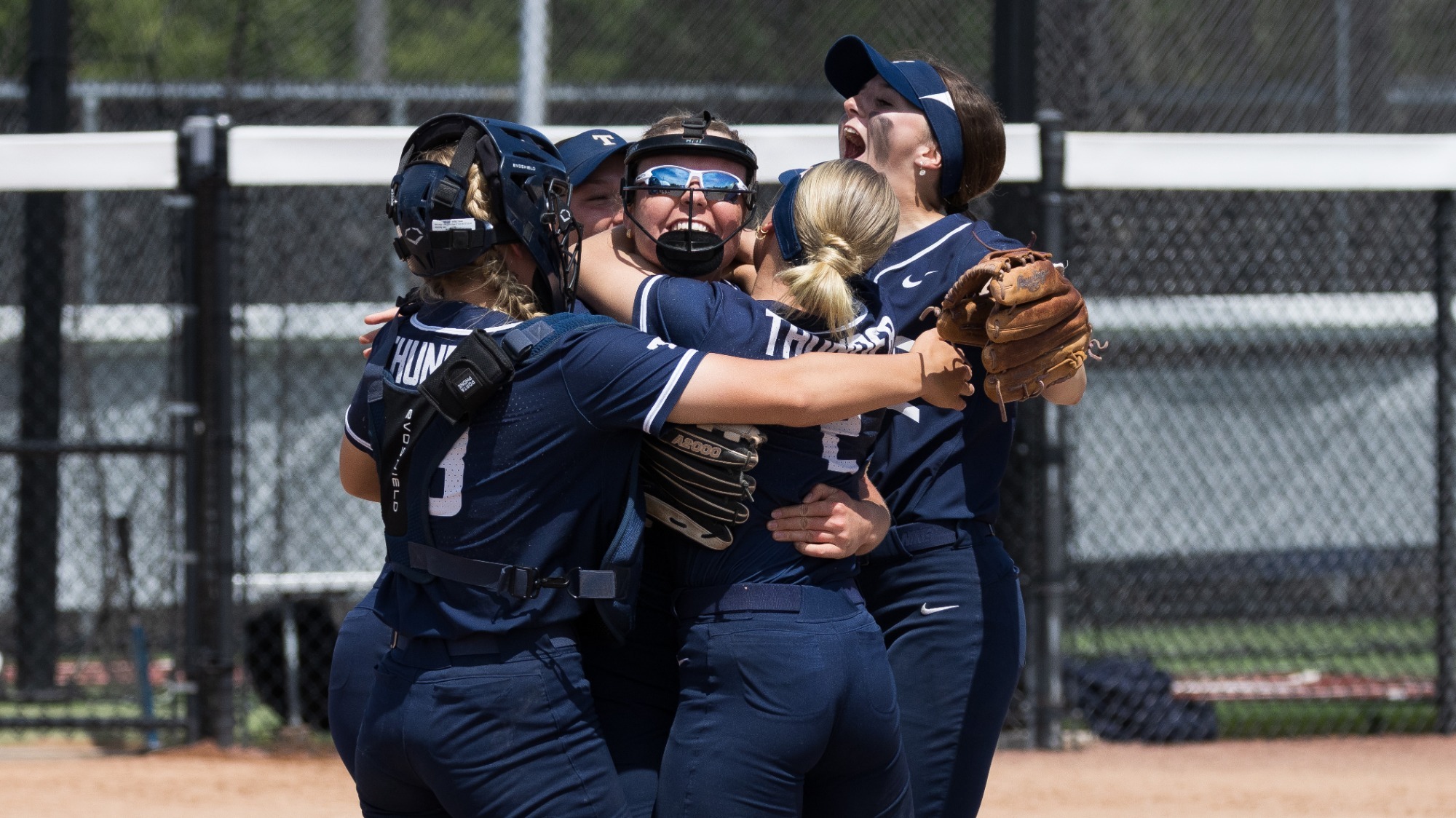 Hill mobbed by teammates after securing a win
