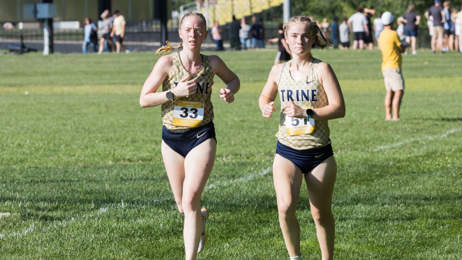 Samantha Wogaman and Laeceigh Farris run at the Manchester Invite