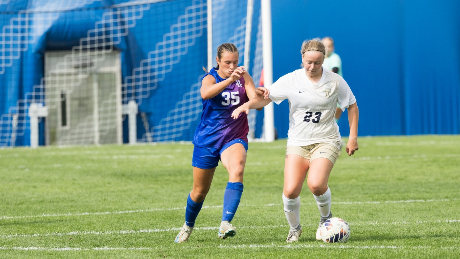 Julia Benham battles for the ball with a defender
