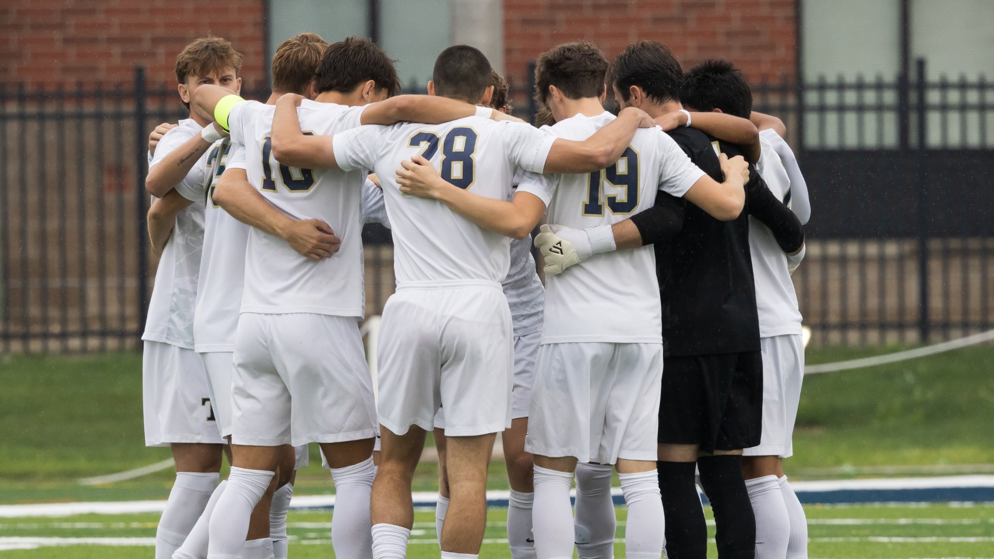 Mens Soccer huddles before the game