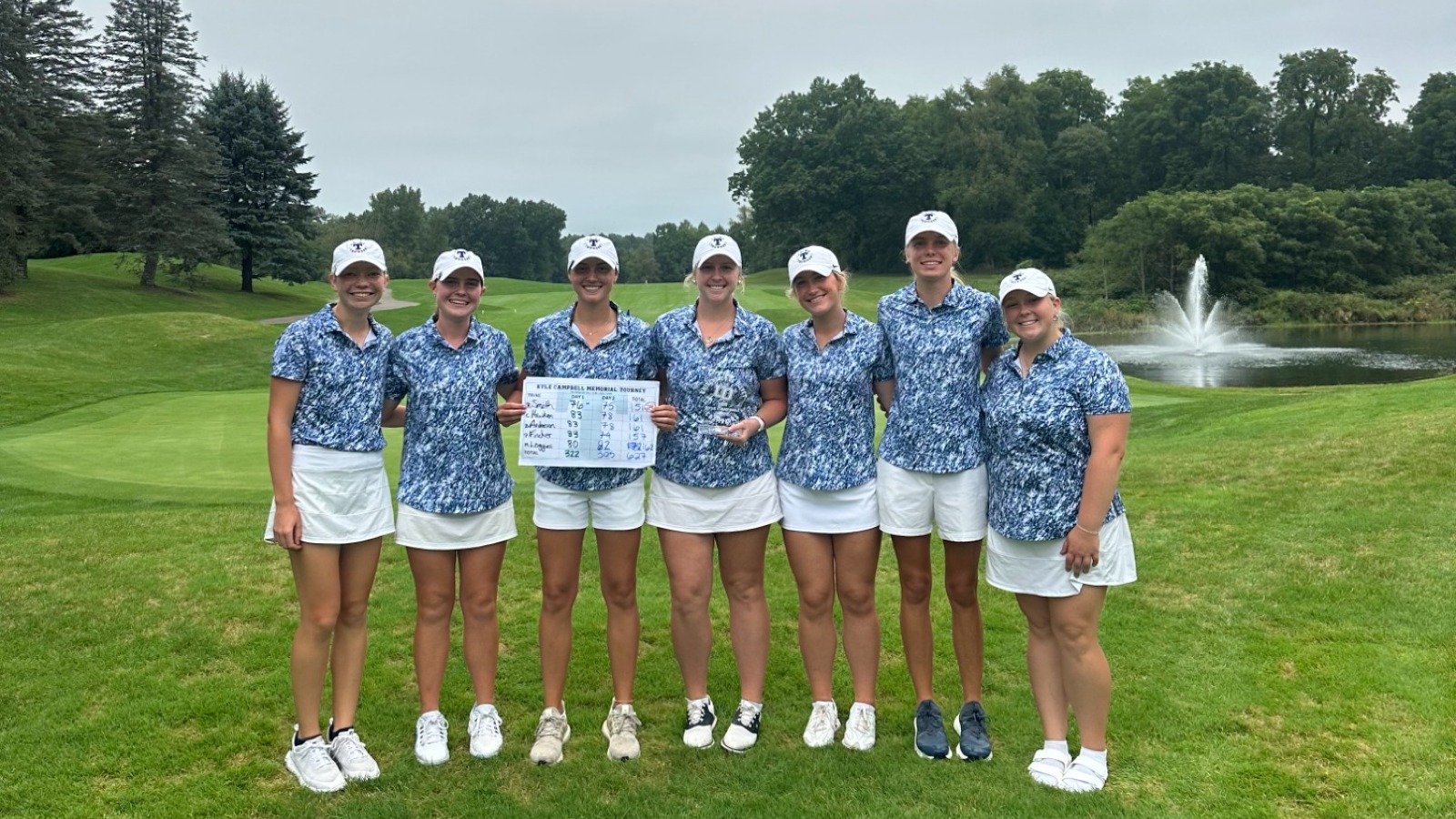The women's golf team poses with the trophy after winning the Kyle Campbell Invitational