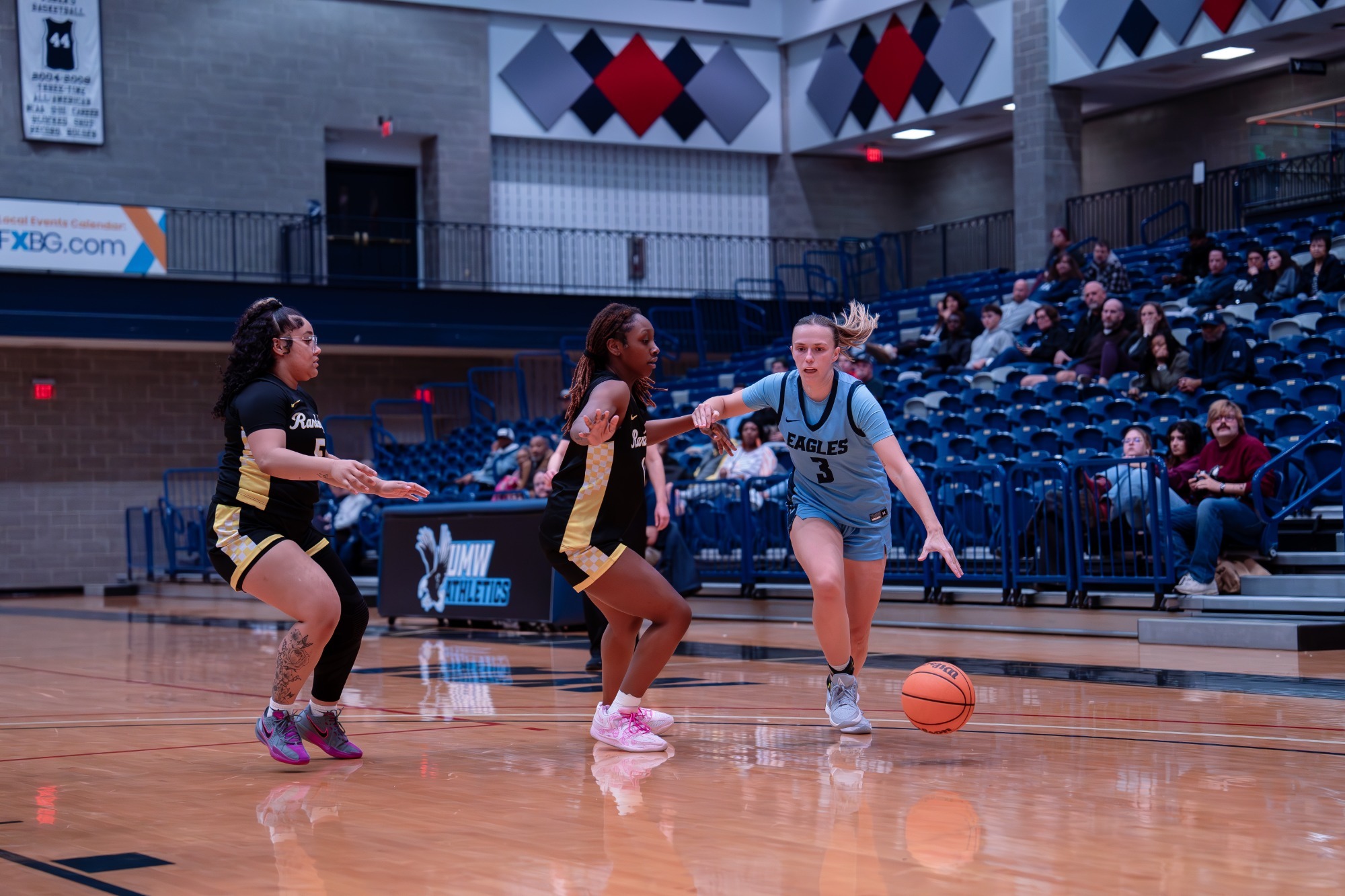 UMW Women's Basketball guard Jenna Steadman dribbles past a few defenders