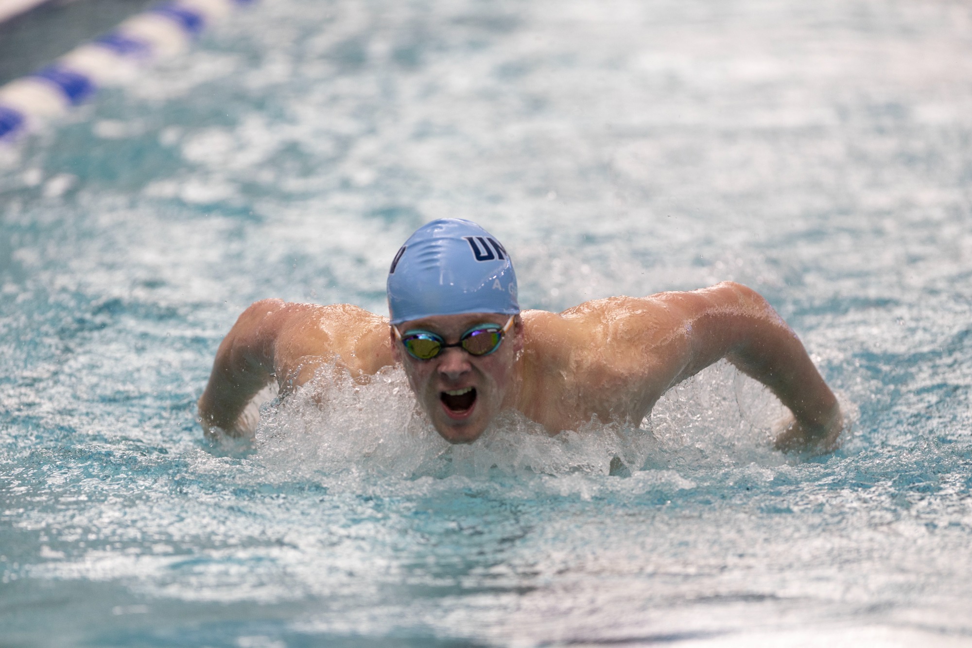 A UMW swimmer swimming in the butterfly