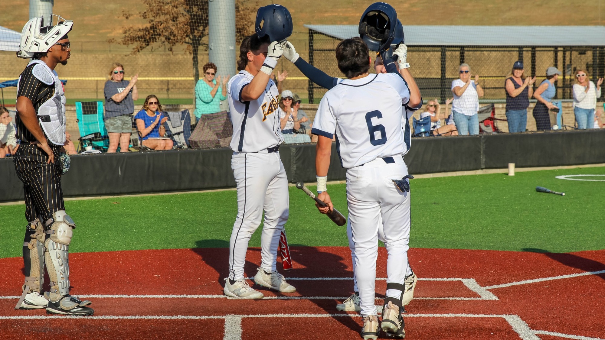 USSU Baseball players celebrating a home run