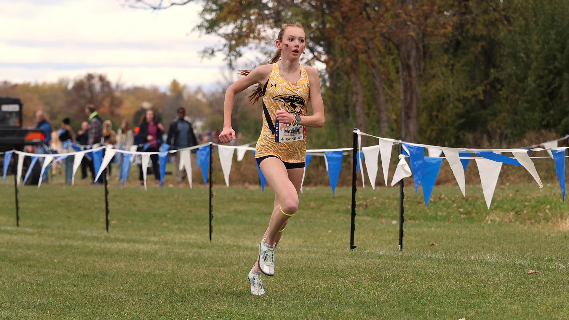 2025 Lehna Mitchell Action Shot, running to the finish line at the WIAC Championship