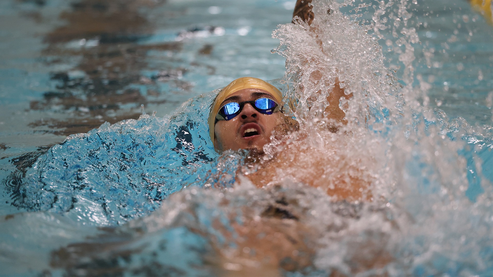 2025 Leo Ramirez-Gutierrez Action Shot, swimming the backstroke against Carroll